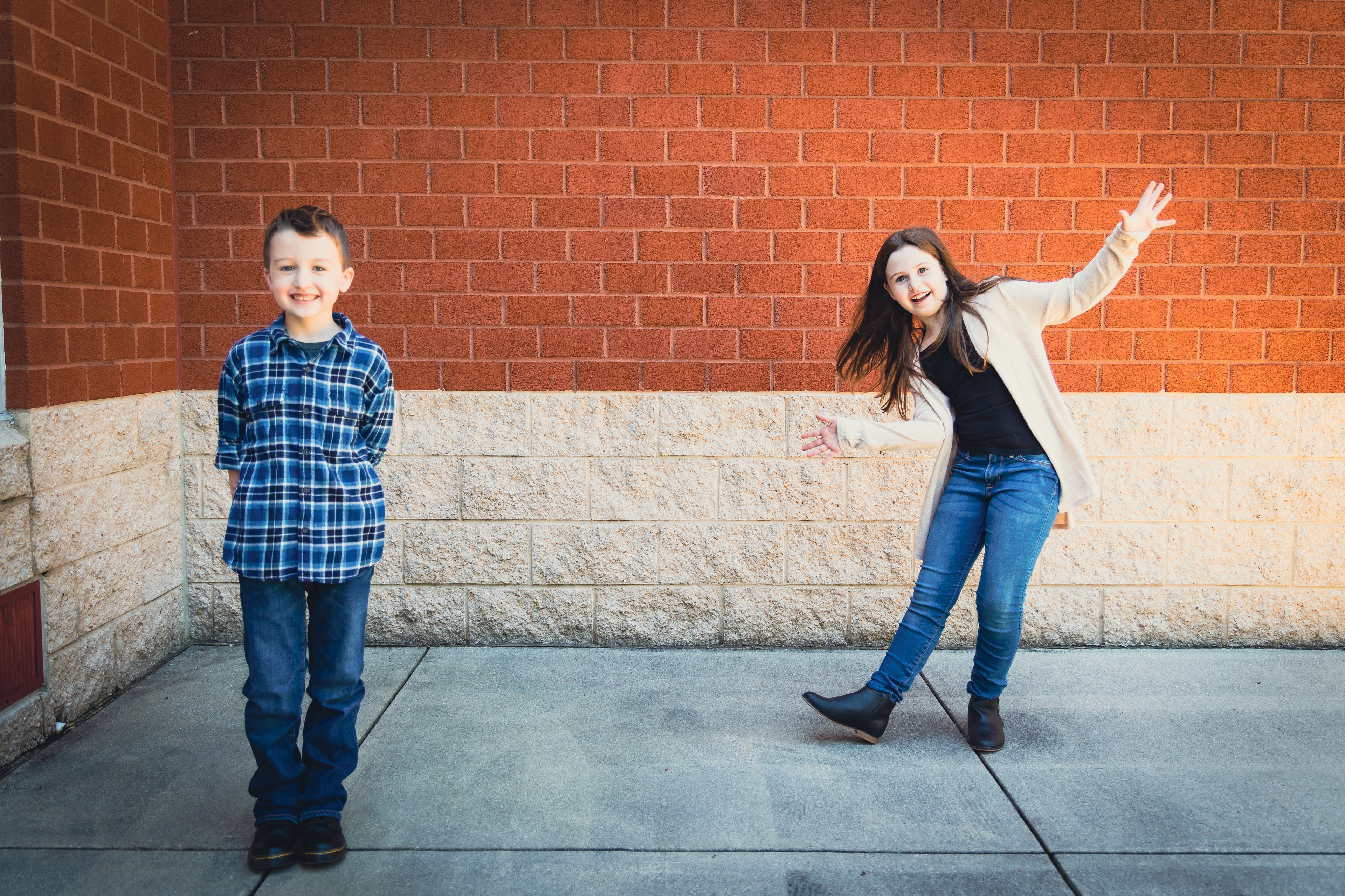 Family posing outdoors together in warm autumn light